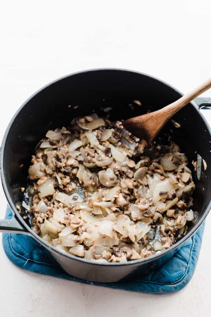 A pot of cooked onions and mushrooms