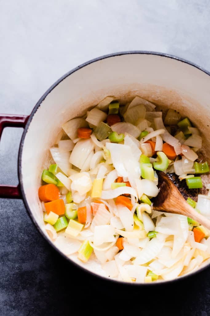 A dutch oven filled with chopped vegetables