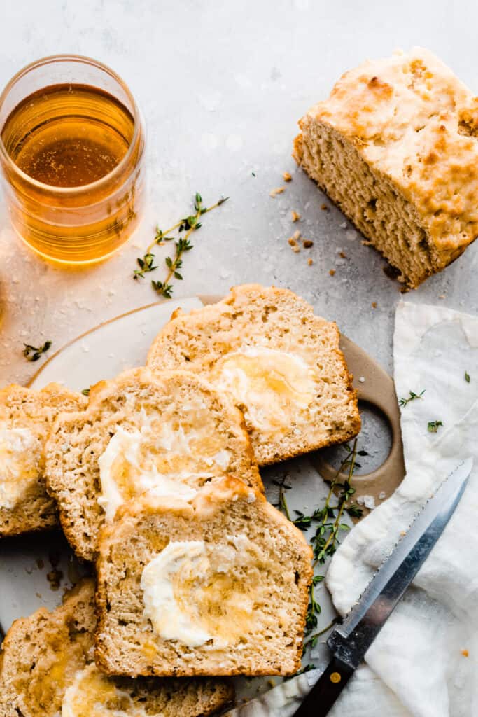 Slices of beer bread slathered with salted honey butter