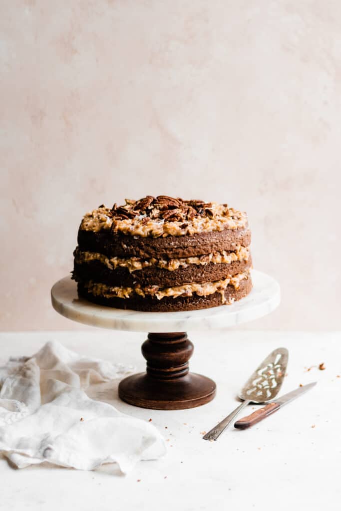 A cake stand with a 3 layer german chocolate cake