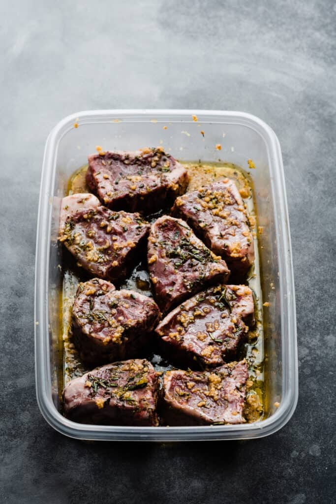 A container with the marinating lamb chops