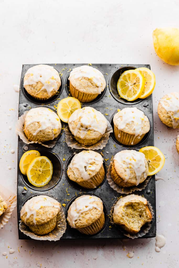 A vintage pan filled with lemon poppyseed muffins and lemon slices