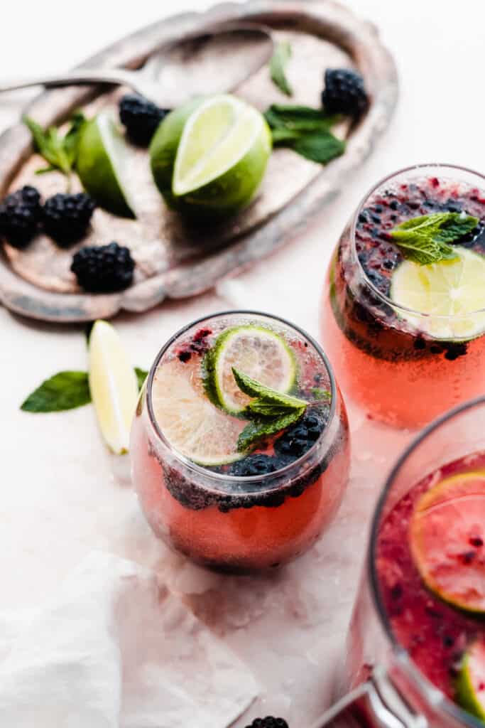 Two glasses of the sangria, topped with lime slices