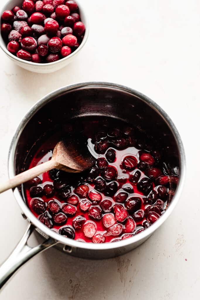 A pot of the cooked, softened cranberries and their simple syrup.