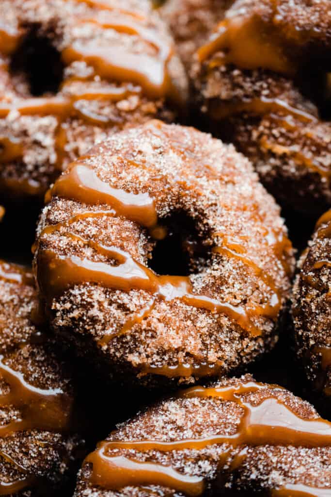 A close-up of a donut drizzled with salted caramel sauce.