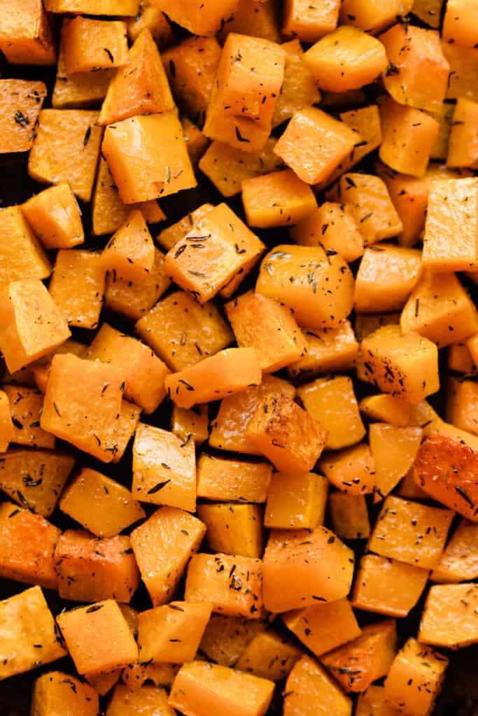A close-up of cubes of seasoned, roasted butternut squash.