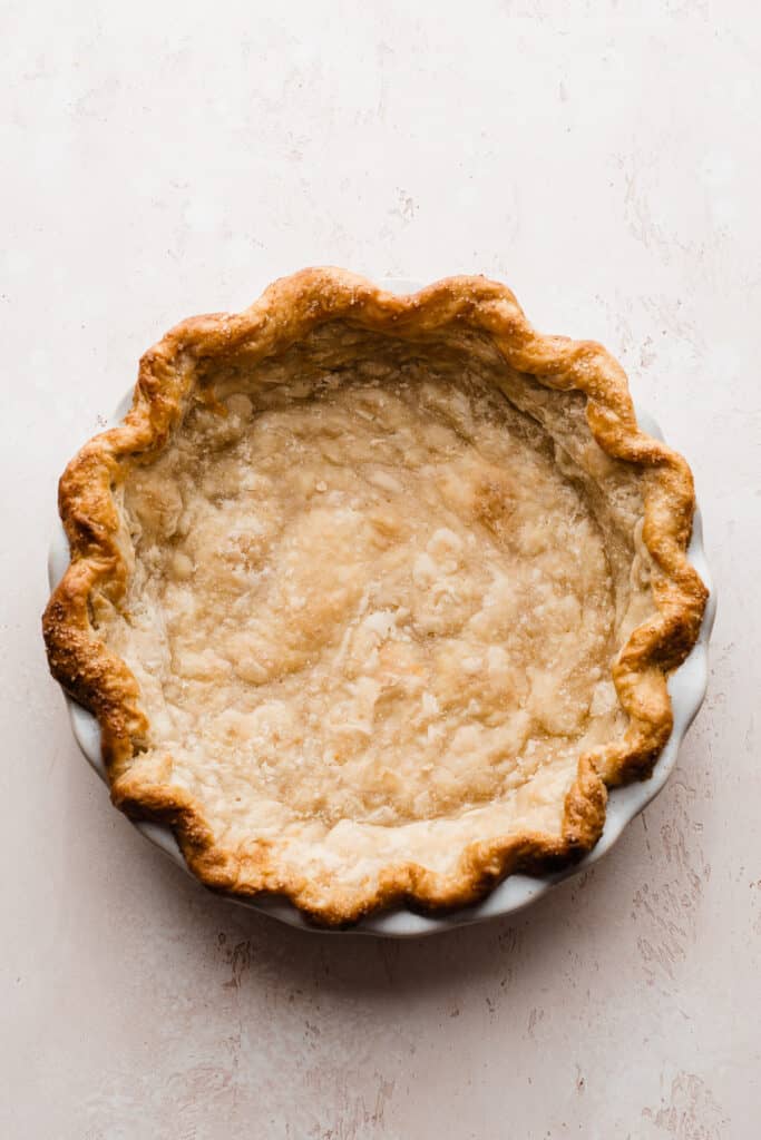 A golden brown, blind-baked pie shell.