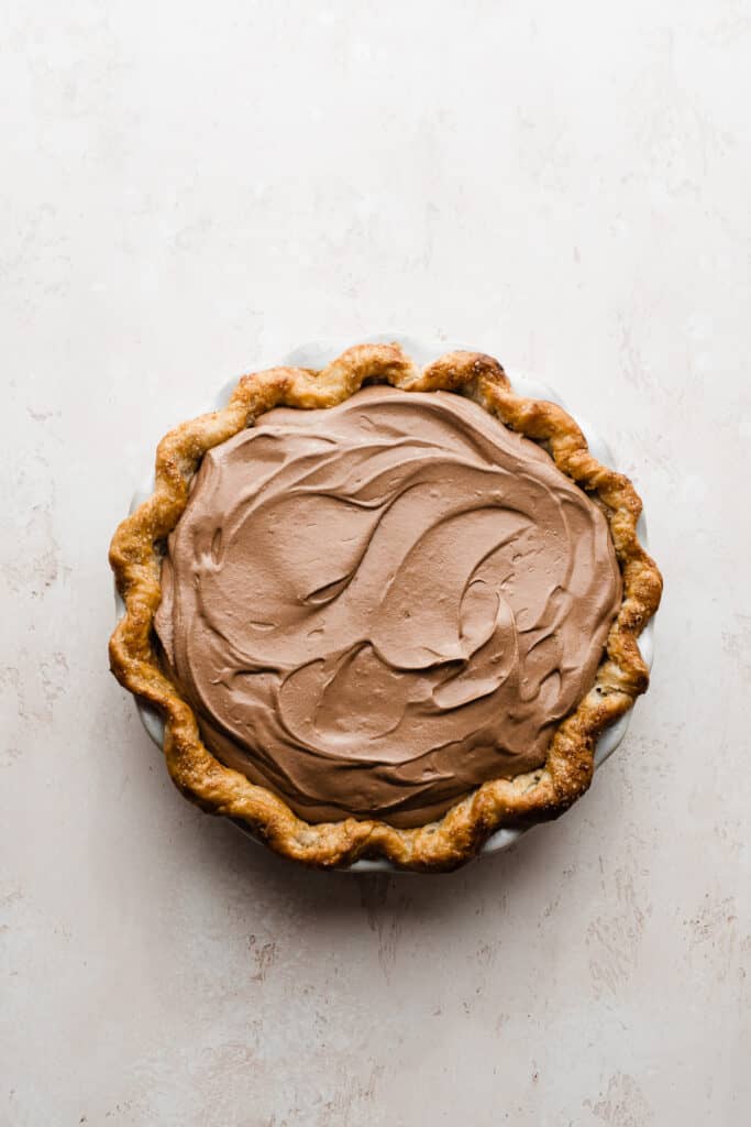 The chocolate filling spread into the prepared pie crust.