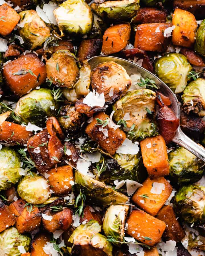 A close-up of the roasted veggies being scooped with a serving spoon.