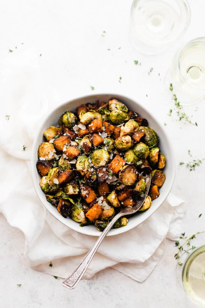 A bowl of the roasted veggies with a serving spoon. 