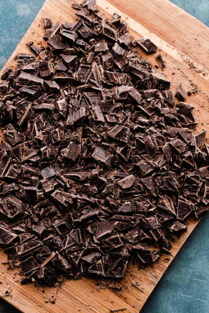 Finely chopped chocolate on a cutting board.
