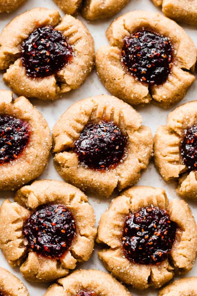 A close-up of the baked pb&J thumbprint cookies in rows.