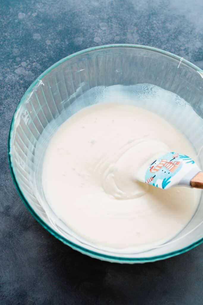 A large mixing bowl of melted white chocolate.