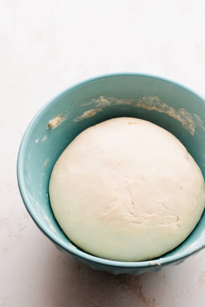 A bowl with twice the amount of dough.