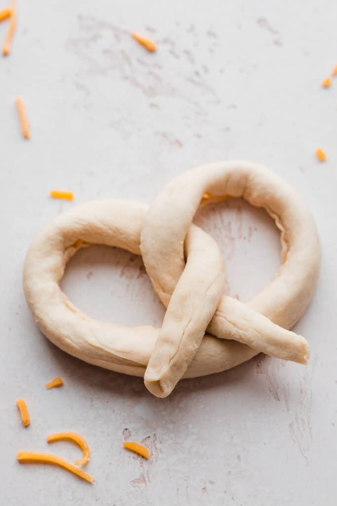 A cheese stuffed, shaped pretzel before being baked.