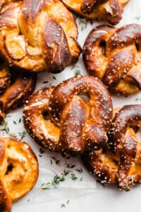 Soft pretzels stuffed with cheese on a light surface.