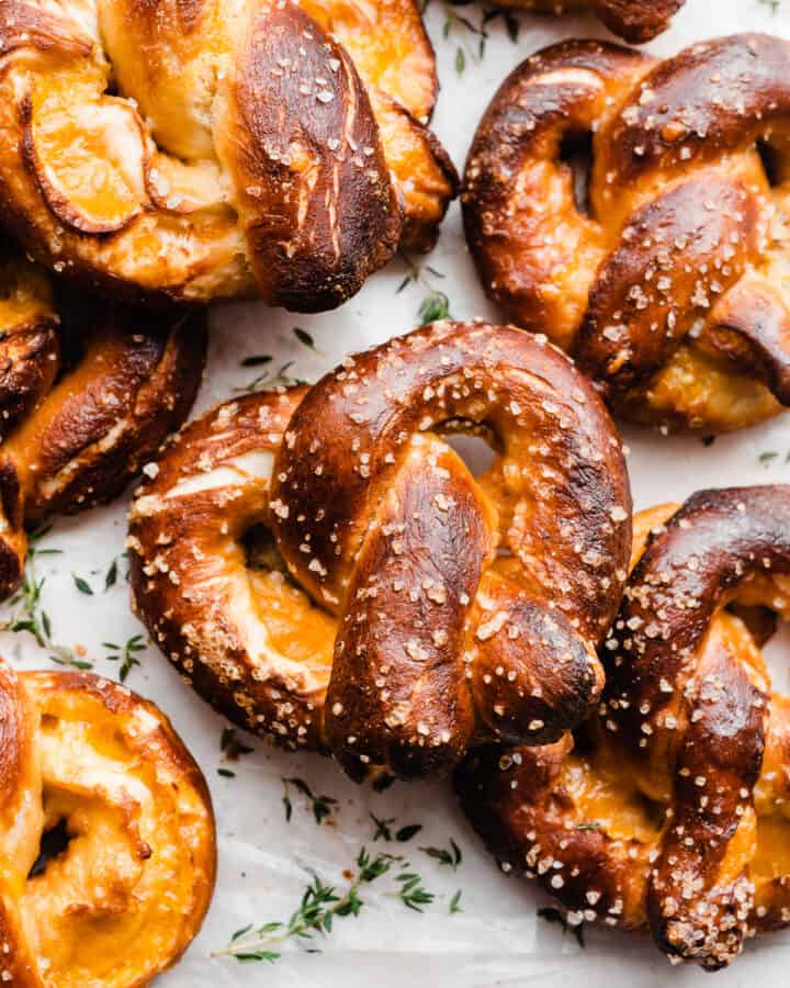 Soft pretzels stuffed with cheese on a light surface.