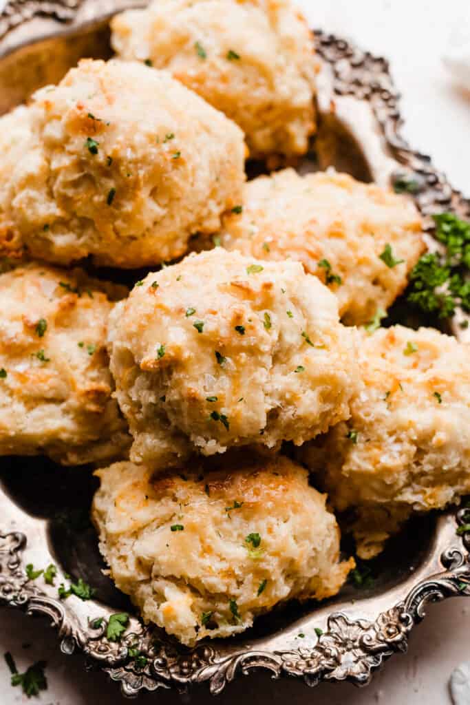 Drop biscuits brushed with butter and sprinkled with flaky sea salt in a serving tray.