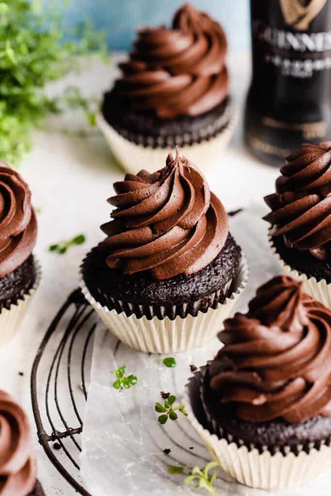 Guinness chocolate cupcakes with a bottle of guinness in the background.