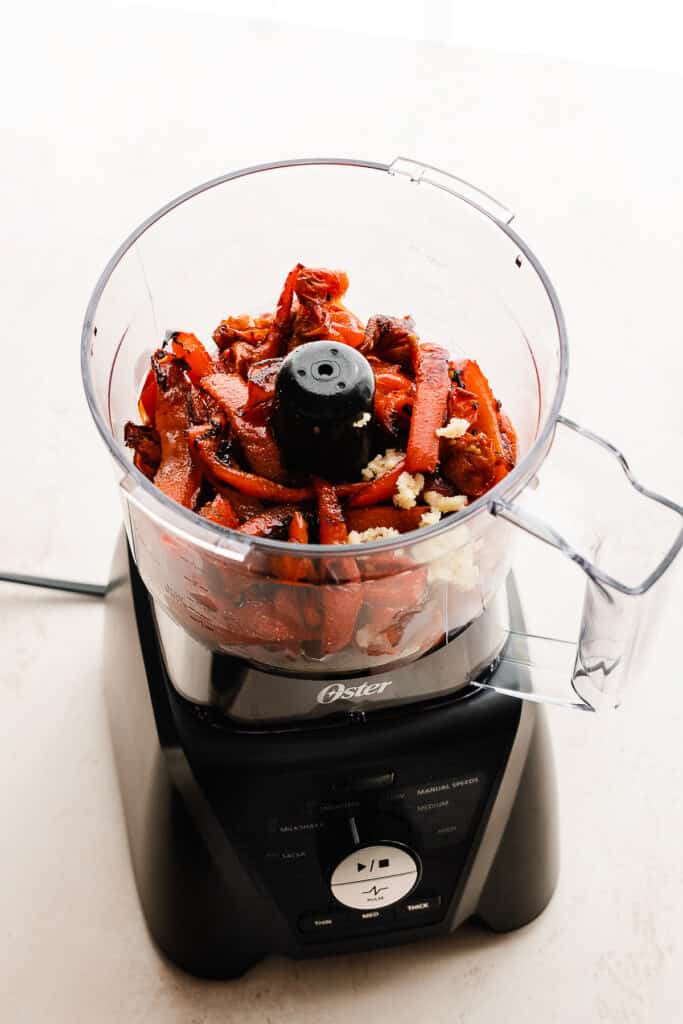 Roasted red peppers and garlic in a food processor.