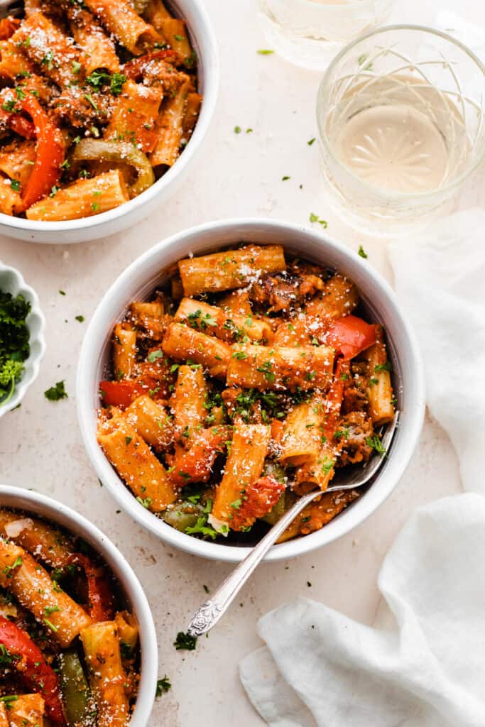 Bowls of the rigatoni topped with fresh parsley and parmesan.