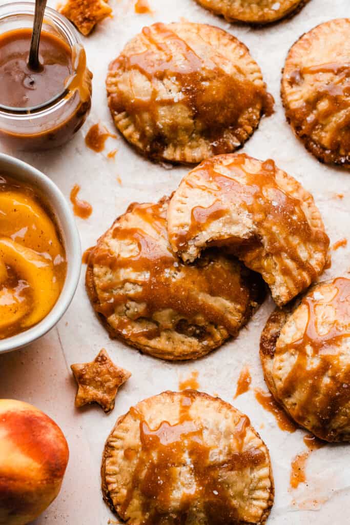 Salted caramel sauce drizzled over peach hand pies.