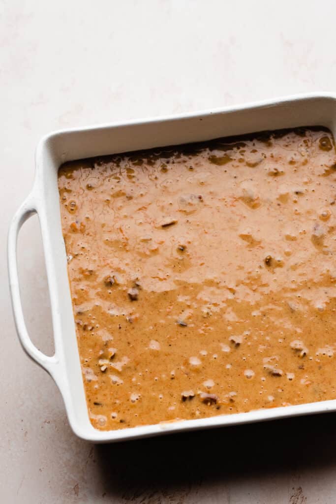 A 9-inch square pan of carrot cake batter.