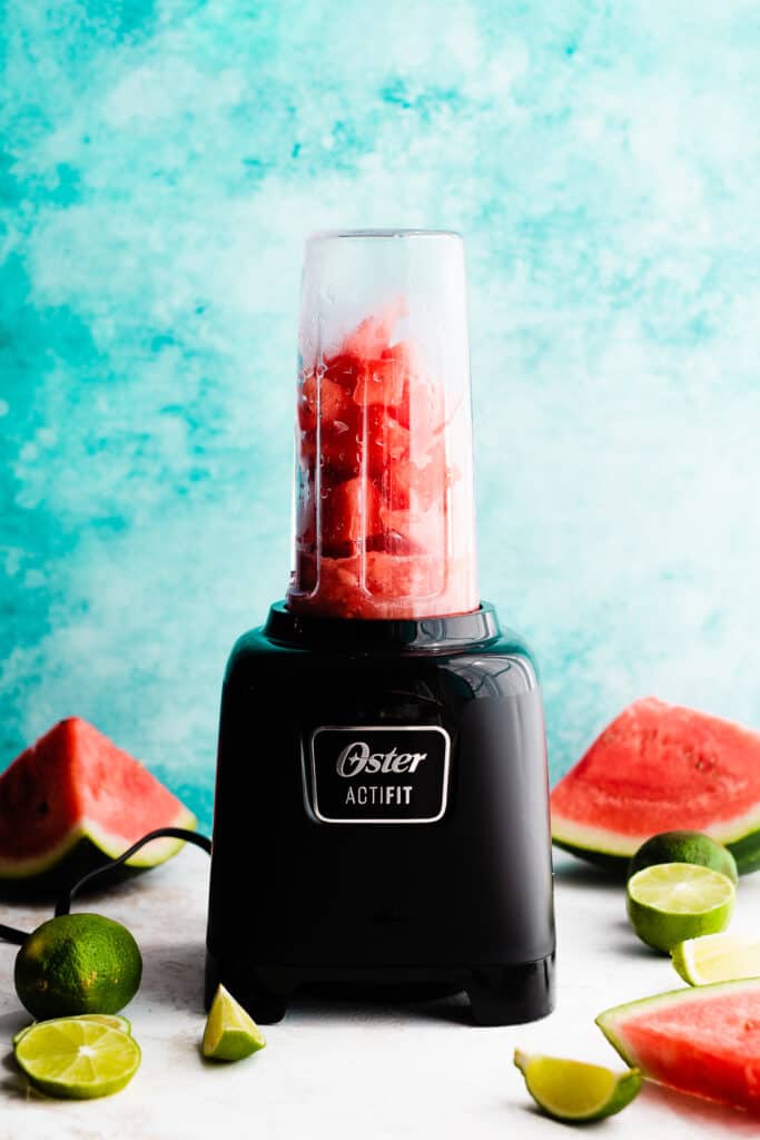 A blender with the margarita ingredients.