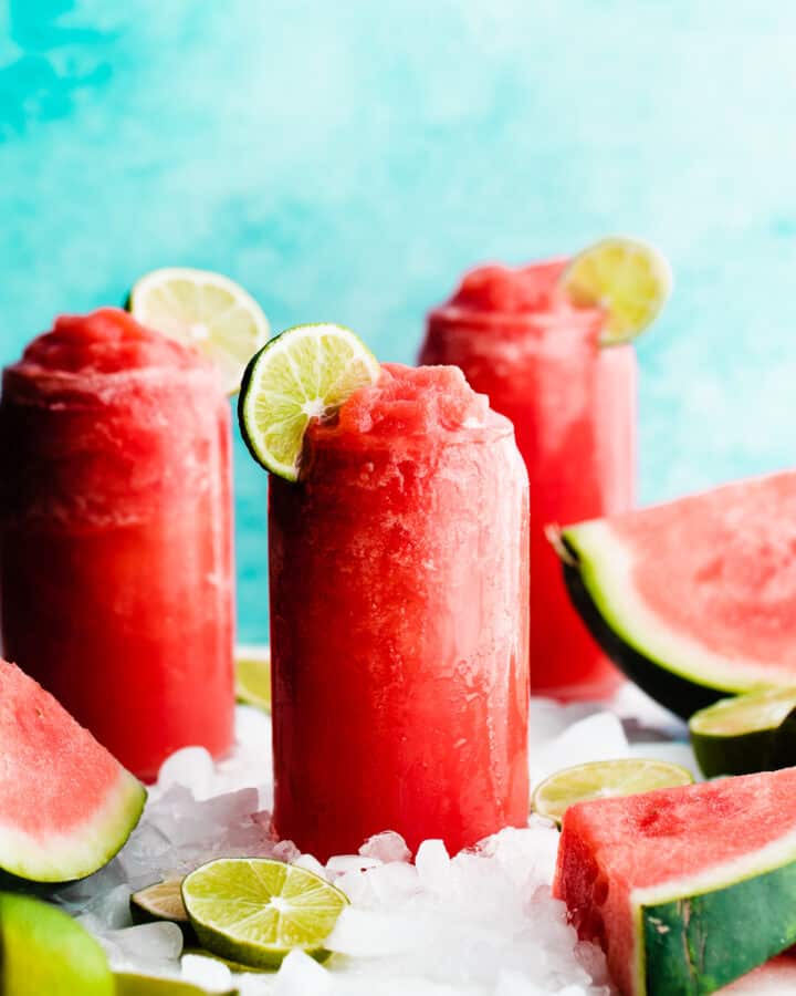 Three glasses of bright pink watermelon margaritas.