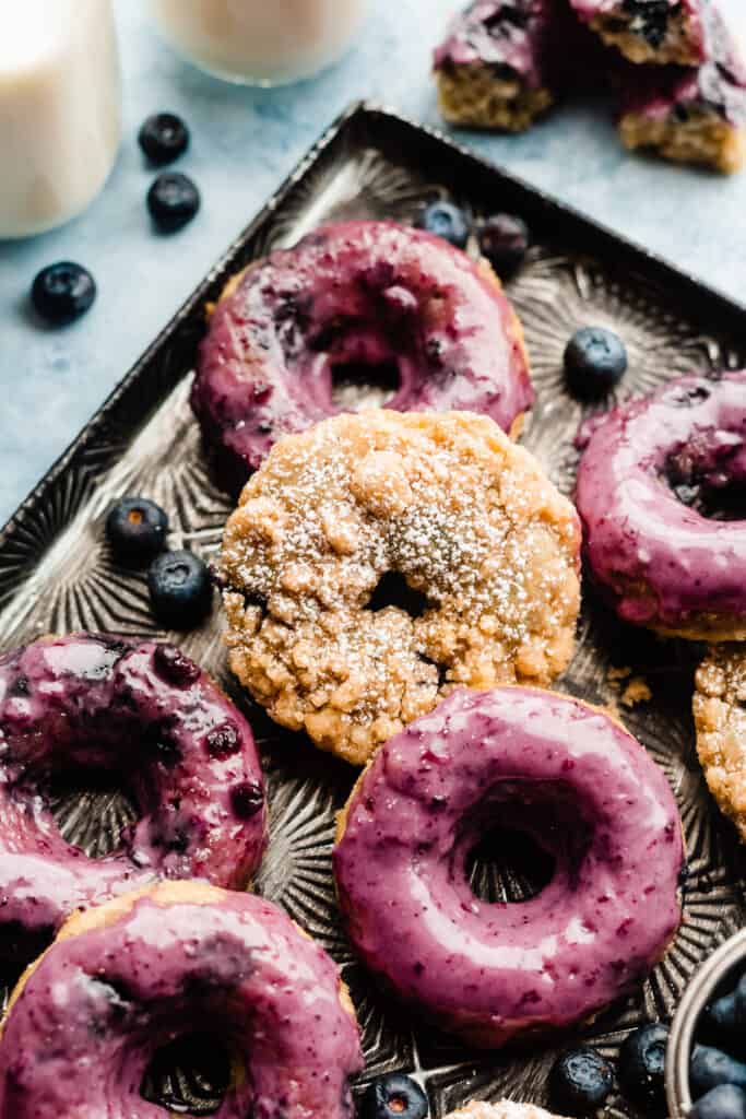 A close-up on the blueberry donuts - some topped with streusel and some with a blueberry glaze.