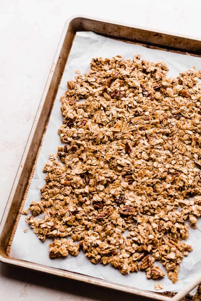 The granola spread on a baking sheet before being baked.