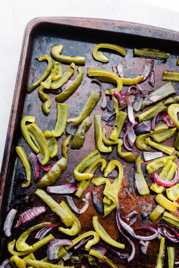 A tray of roasted peppers and onions.