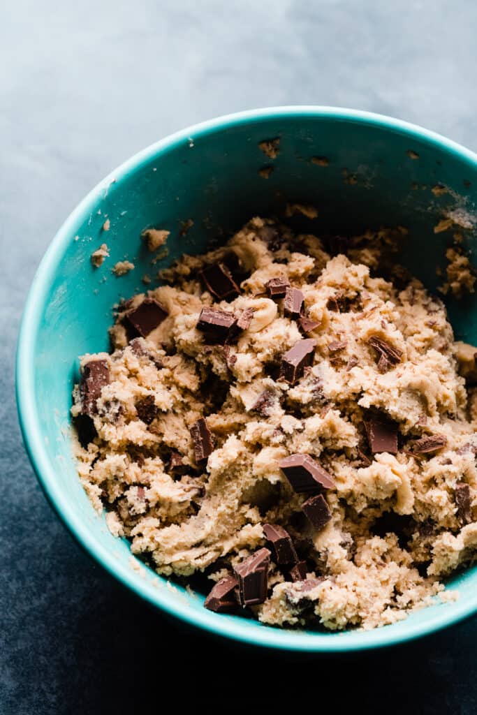 A mixing bowl full of chocolate chunk cookie dough.