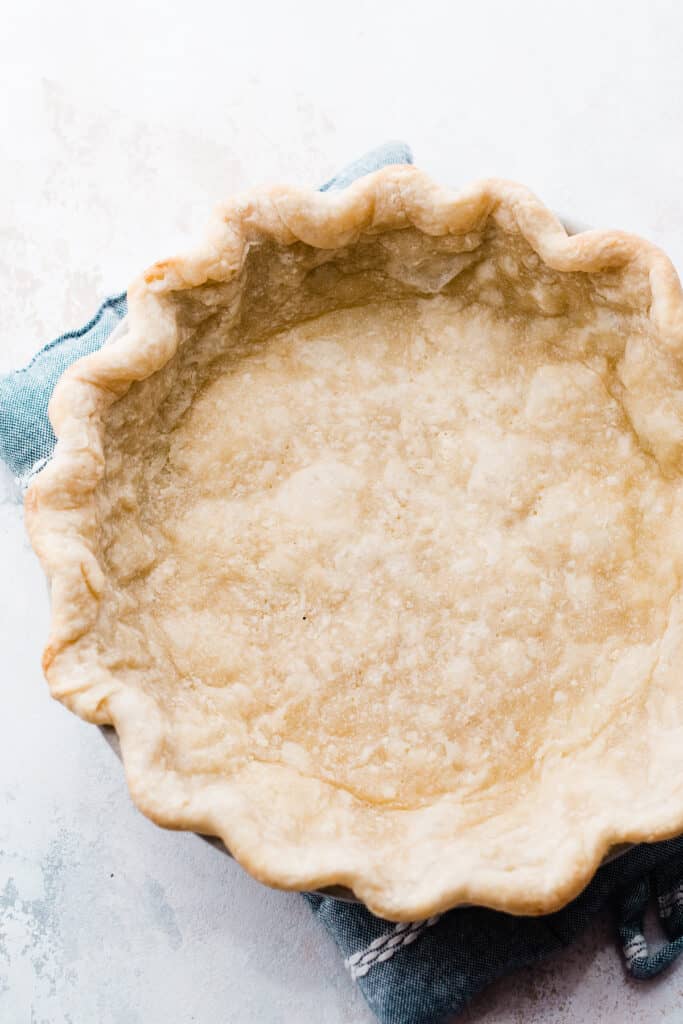 The lightly browned par-baked pie crust.
