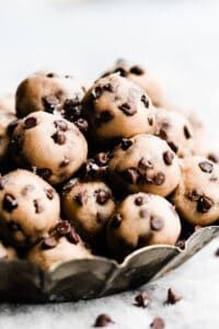 No bake cookie dough bites piled in a metal tray.