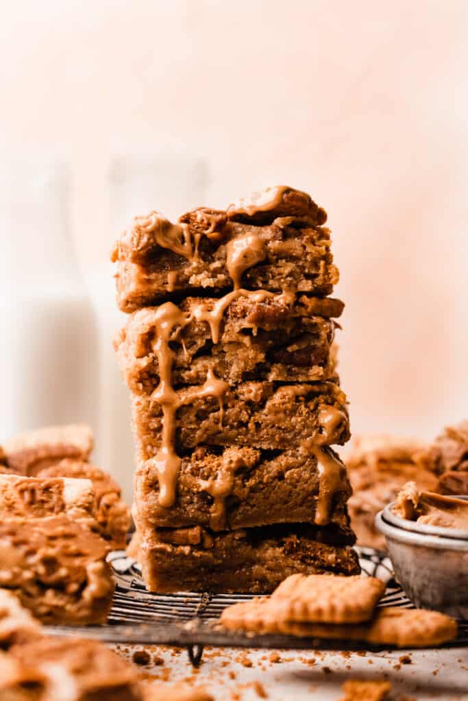 A stack of cookie butter blondies with cookie buter dripping down.