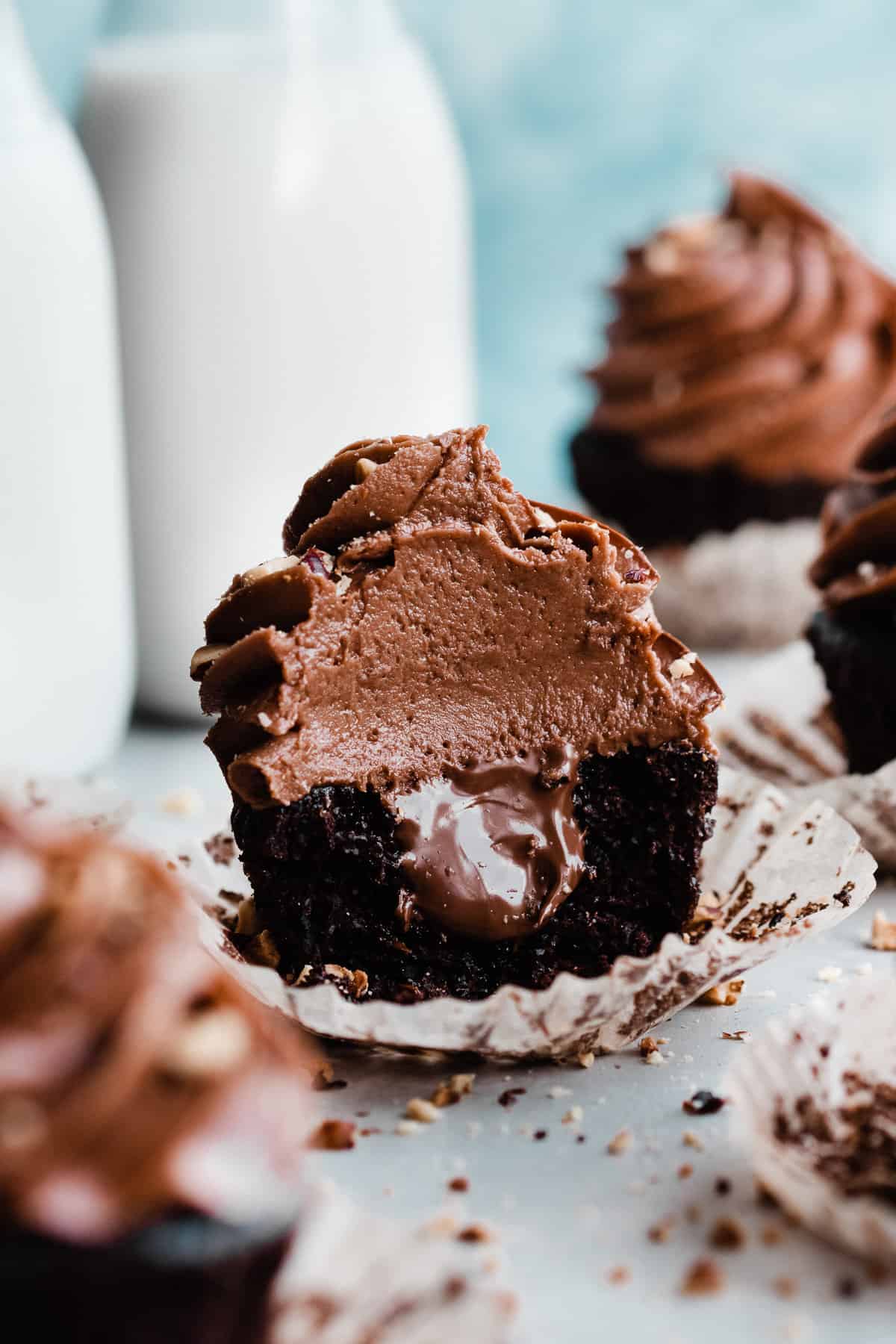 A nutella cupcake with a bite missing and gooey nutella showing in the center.
