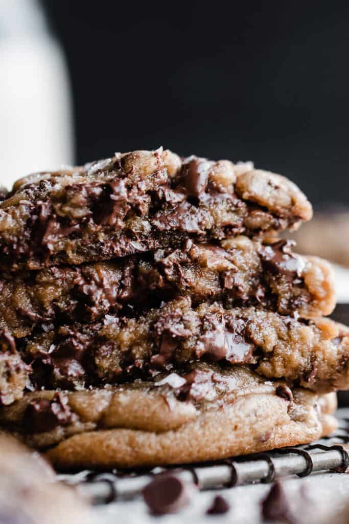 A close-up on a stack of chocolate cip cookies broken open.