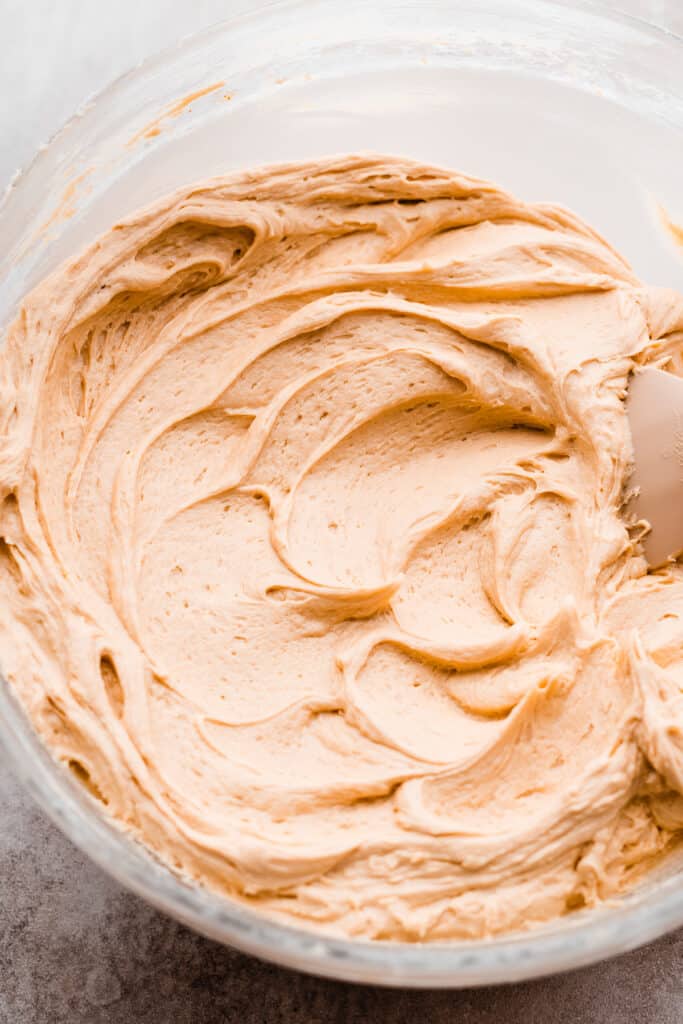 A bowl of creamy butterscotch cream frosting.