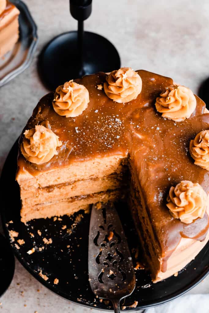 A top-down view of the cake with butterscotch sauce and piped frosting swirls on top.