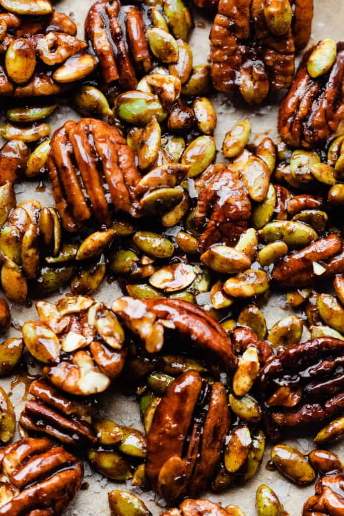 A close-up of candied pecans and pepitas.