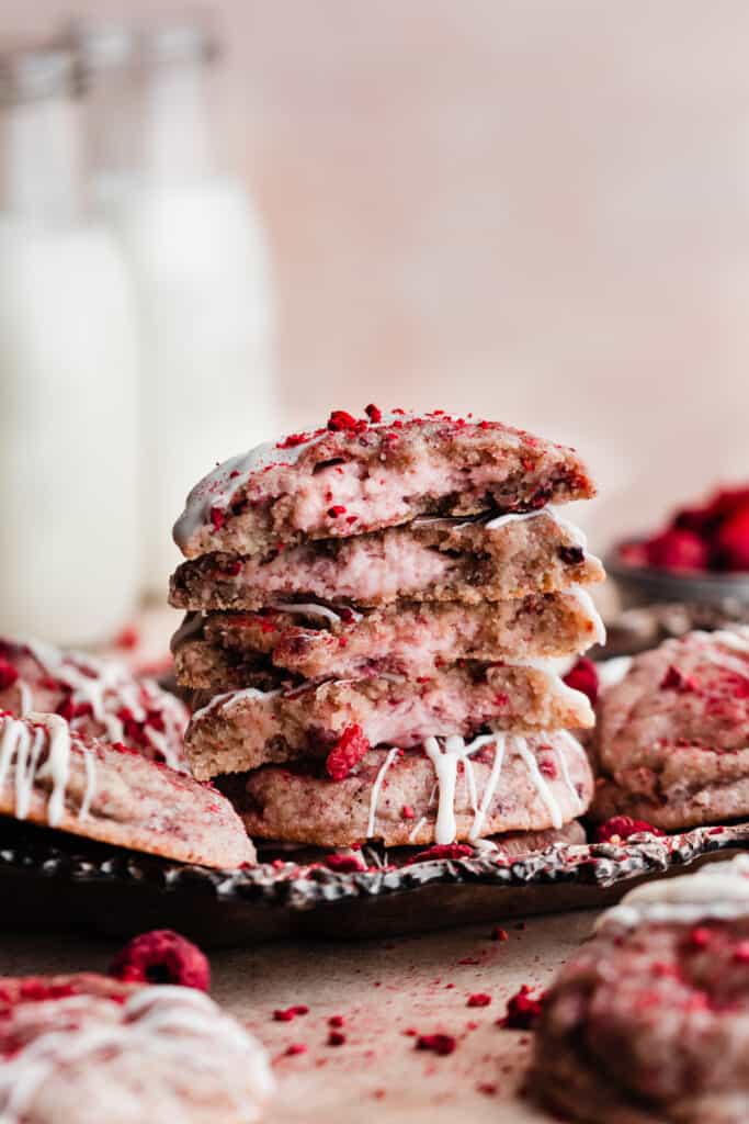 A stack of raspberry cheesecake cookies with the cheesecake filling visible in the centers.