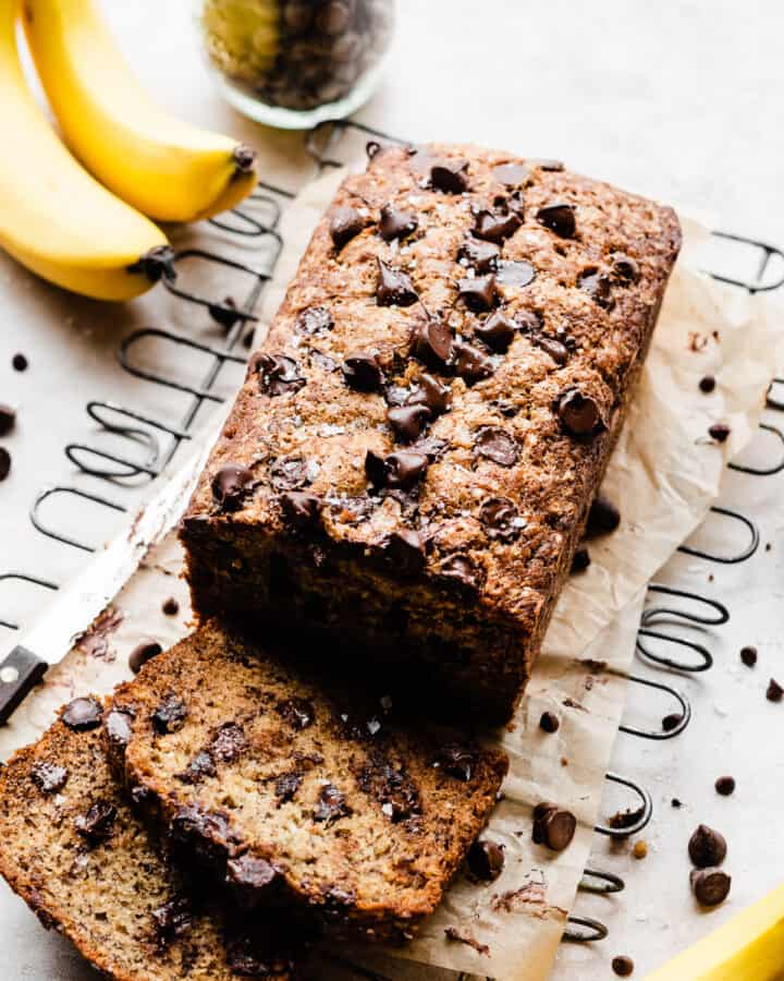 A sliced loaf of warm chocolate chip banana bread.