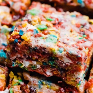 A close-up of a fruity pebble treat with cereal glaze.