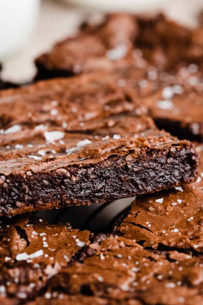 A close-up on one brownie, showing the fudgy insides.