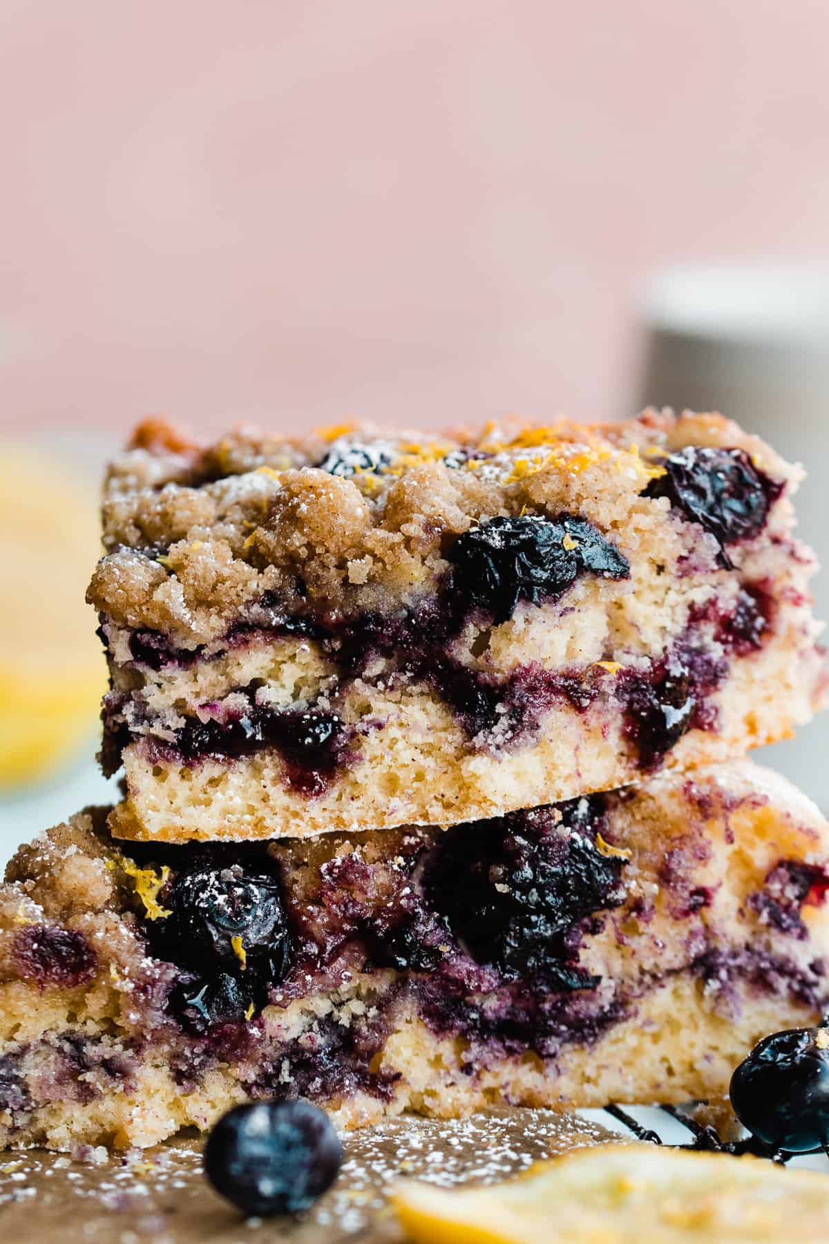 A stack of blueberry lemon coffee cake slices with blueberries and a blueberry jam ripple.