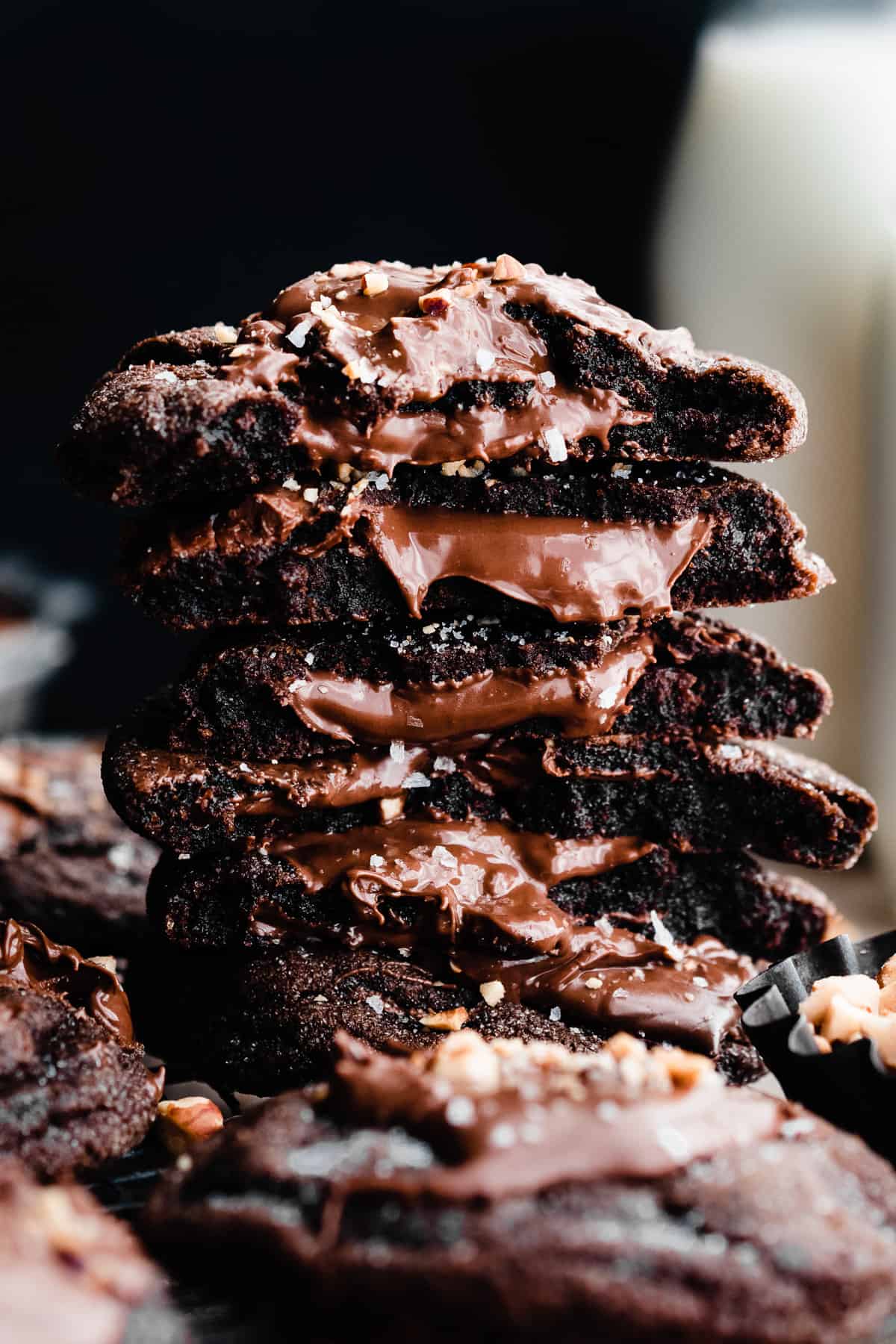 A stack of nutella cookies with gooey nutella oozing from the centers.