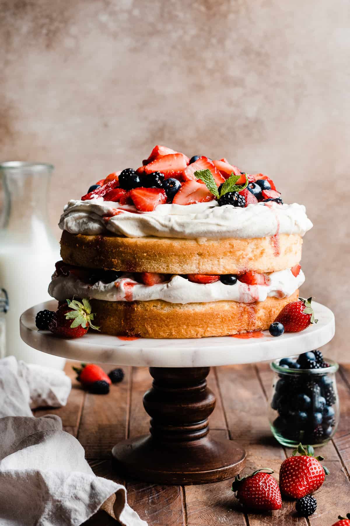 Two layers of vanilla cake with whipped cream and fresh berries.