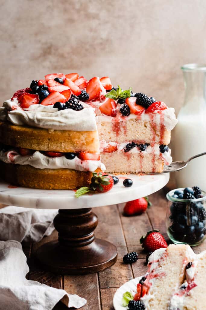 The sliced berry cake on a cake stand.