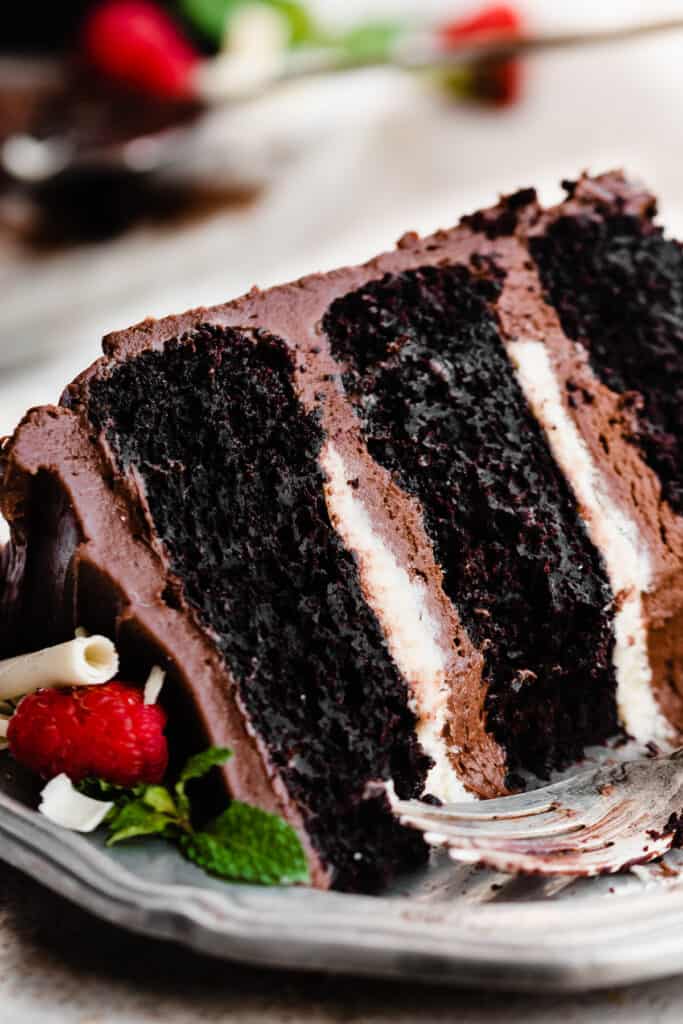 A close-up on a slice of tuxedo cake with a few bites missing.